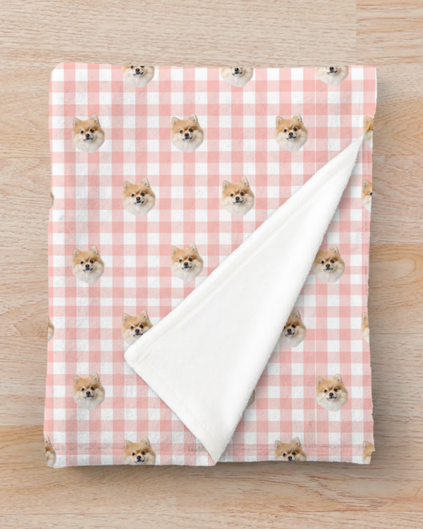 Blanket with dog pattern on a pink and white checkered background