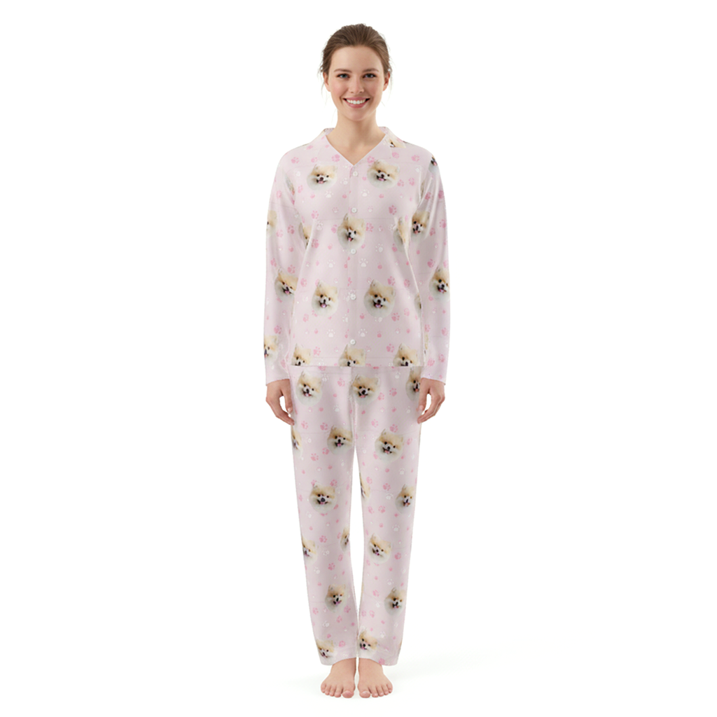 Woman wearing a pink pajama set with dog pattern on a white background