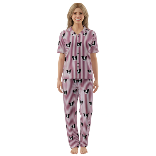 Woman wearing a pink pajama set with black and white patterns on a white background