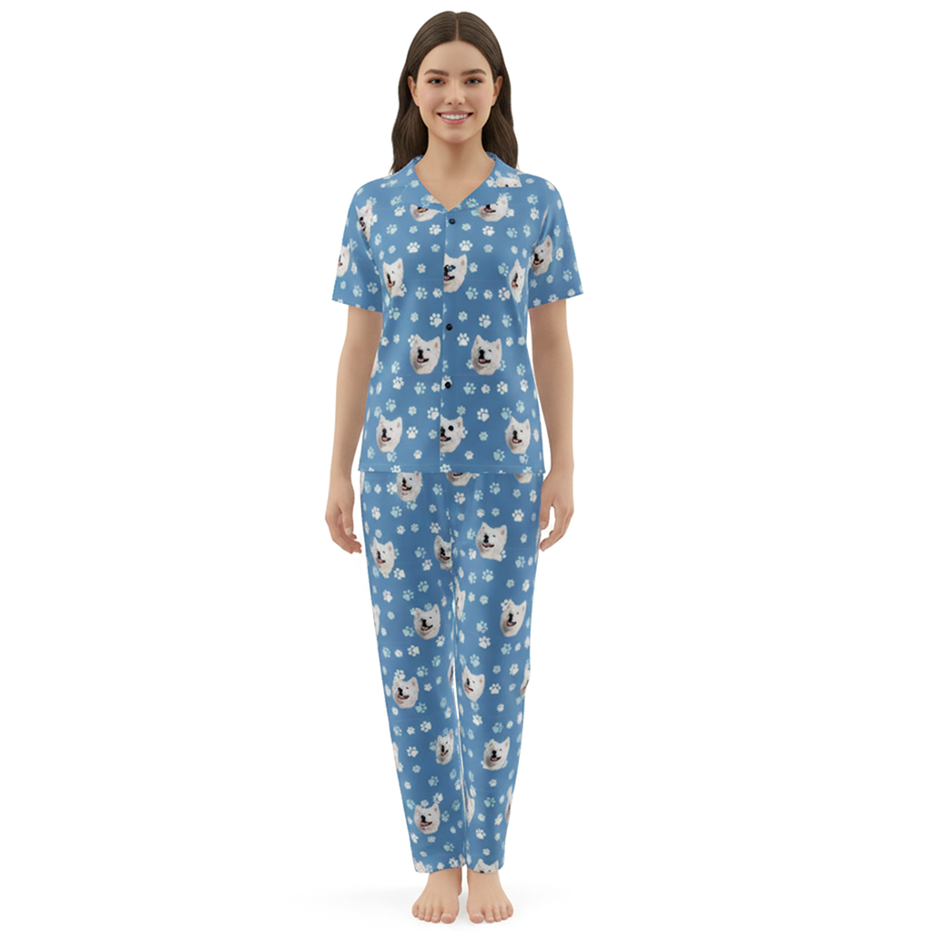 Woman wearing a blue pajama set with dog pattern on a white background