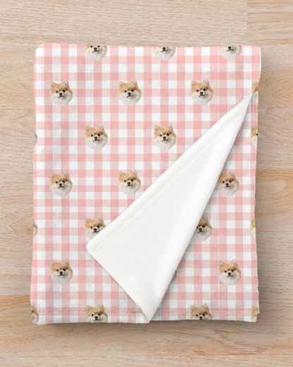Blanket with dog pattern on a pink and white checkered background