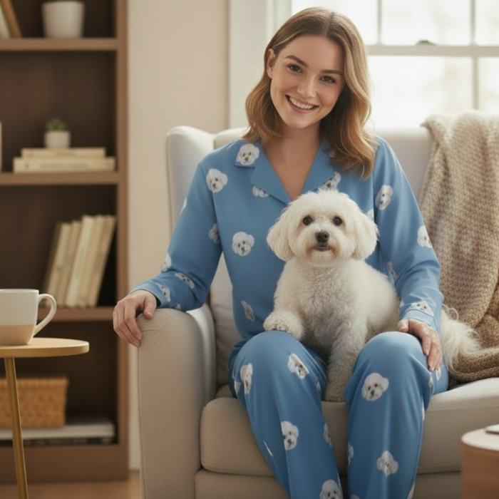 Custom Pet Face Pajama,Woman in blue pajamas with dog patterns sitting on a couch holding a small white dog.