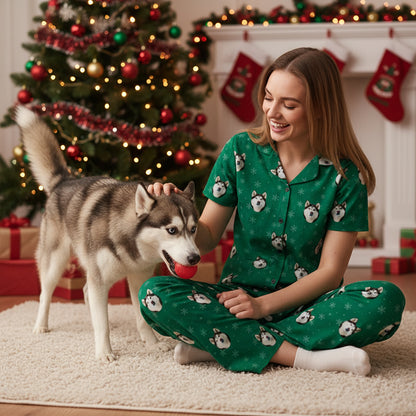 Custom_Pet_Face_Pajama_xm_Green_SnowFlakes_Woman in matching pajamas with a dog in a festive room with Christmas decorations.