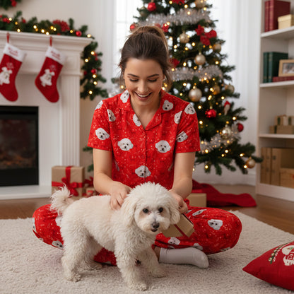 Custom_Pet_Face_Short_Pajama_xm_deer_foliage_Christmas_Woman in red pajamas with a white dog in a festive living room with Christmas tree and stockings.