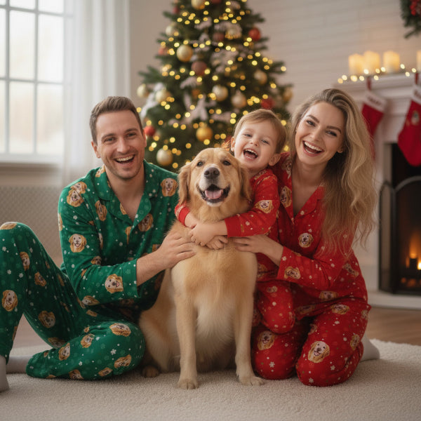 Family of three with a dog in matching pajamas in front of a Christmas tree.