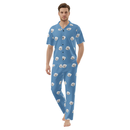 Man wearing a blue pajama set with dog pattern on a white background