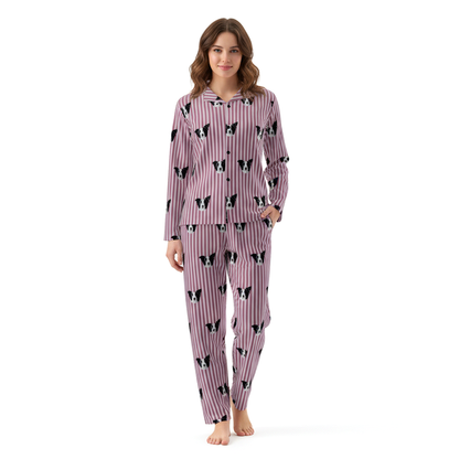 Woman wearing a pink pajama set with black and white dog pattern on a white background