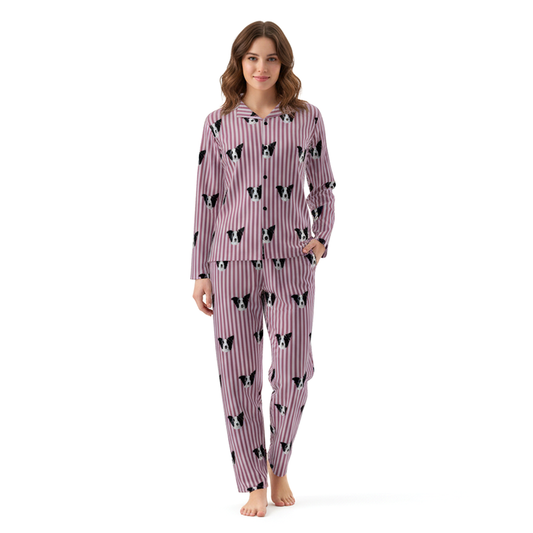 Woman wearing a pink pajama set with black and white dog pattern on a white background