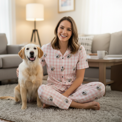 Woman in pink pajamas with dog sitting on floor in living room