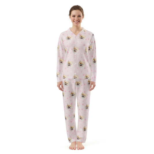 Woman wearing a pink pajama set with dog pattern on a white background