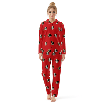 Person wearing a red pajama set with dog pattern on a white background