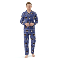 Man wearing a blue plaid pajama set with dog pattern on a white background
