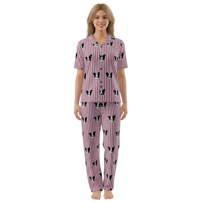 Woman wearing a pink pajama set with black and white patterns on a white background