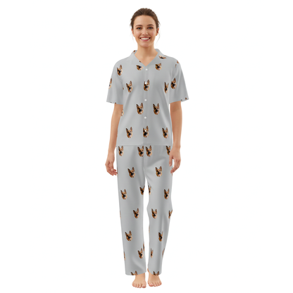 Woman wearing a light gray pajama set with dog pattern on a white background