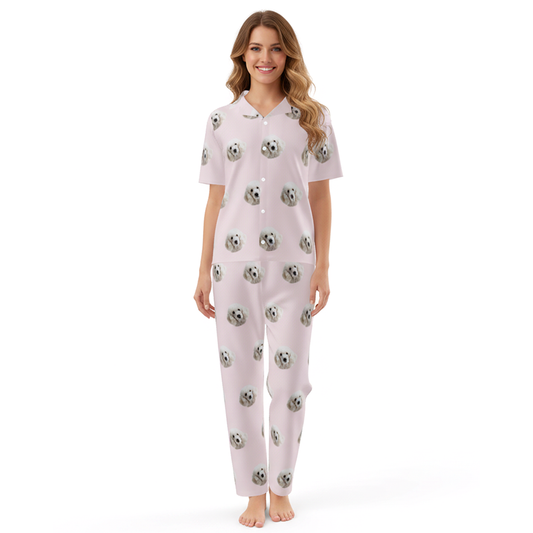 Woman wearing a light pink pajama set with soccer ball pattern on a white background