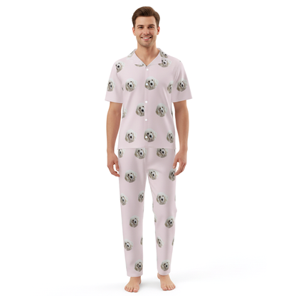 Man wearing a light pink pajama set with a pattern on a white background