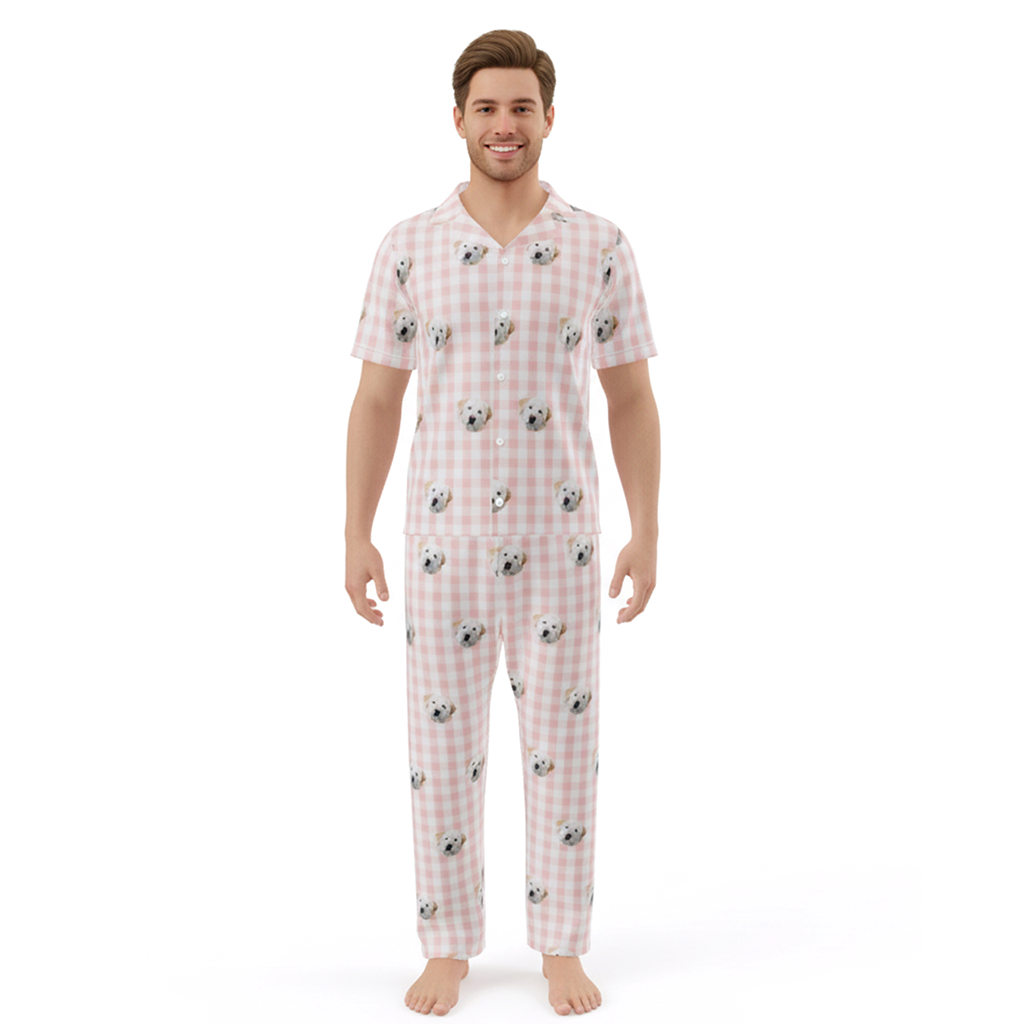 Man wearing a pink checkered pajama set with dog pattern on a white background