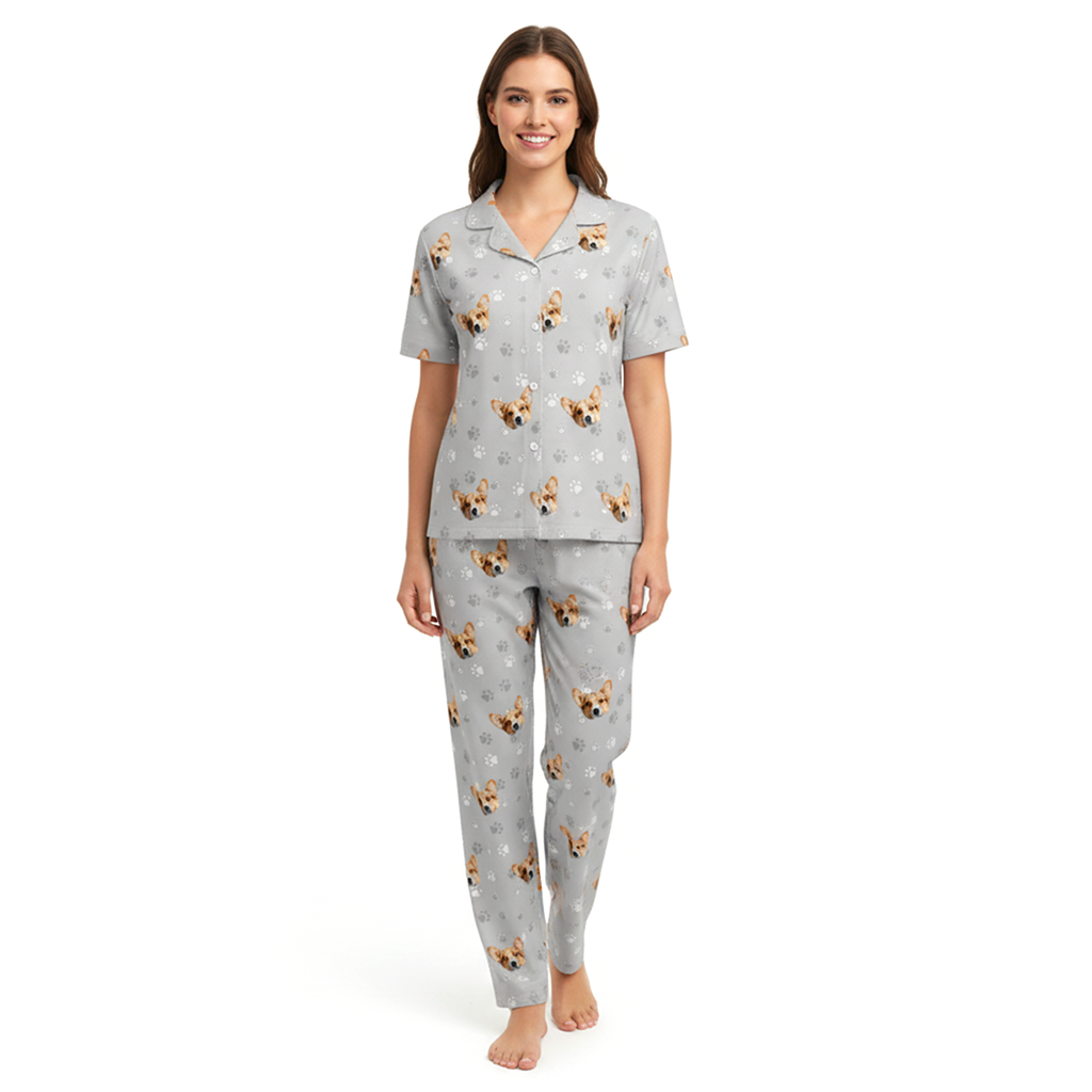 Woman wearing a gray pajama set with dog pattern on a white background