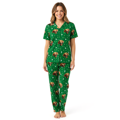 Woman wearing a green pajama set with dog pattern on a white background