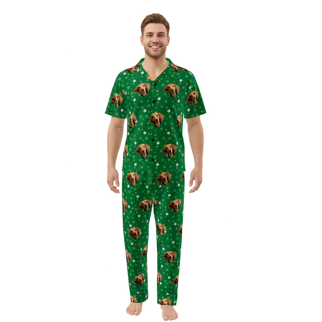Man wearing a green pajama set with dog pattern on a white background