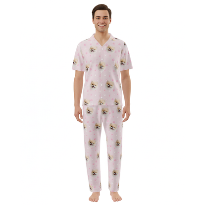 Man wearing pink pajamas with dog pattern on a white background