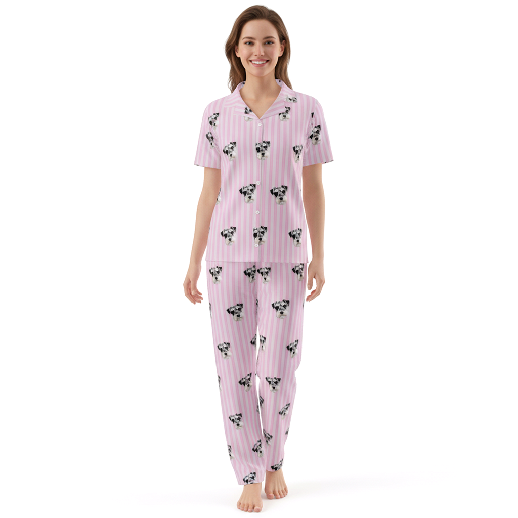 Woman wearing a pink pajama set with dog pattern on a white background